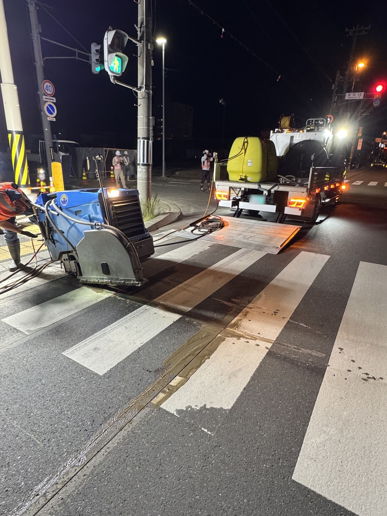 夜間、横断歩道の路面をフラットソーイングで切断する様子