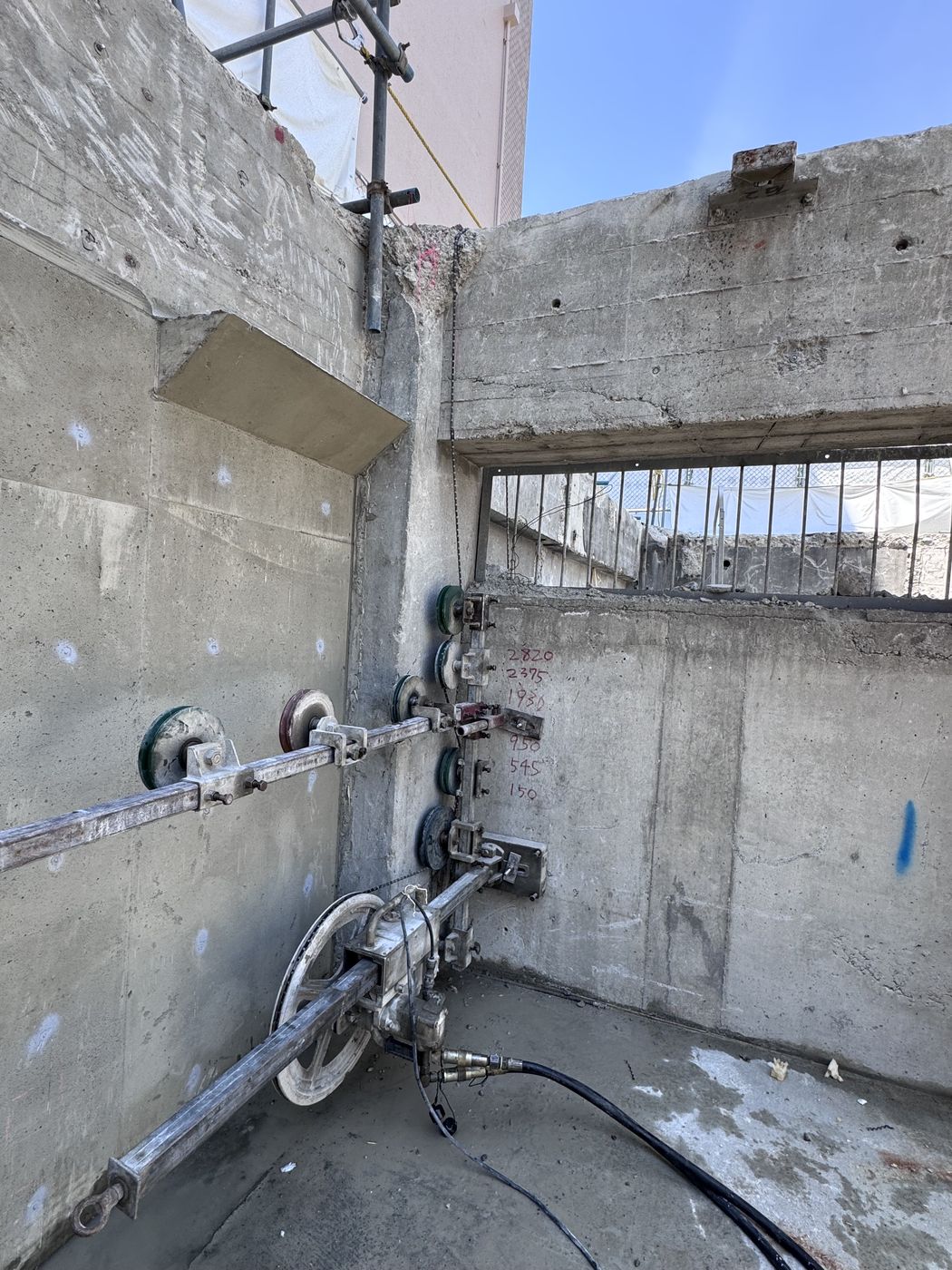 建物内の壁にレールを設置してウォールソーで切断する様子